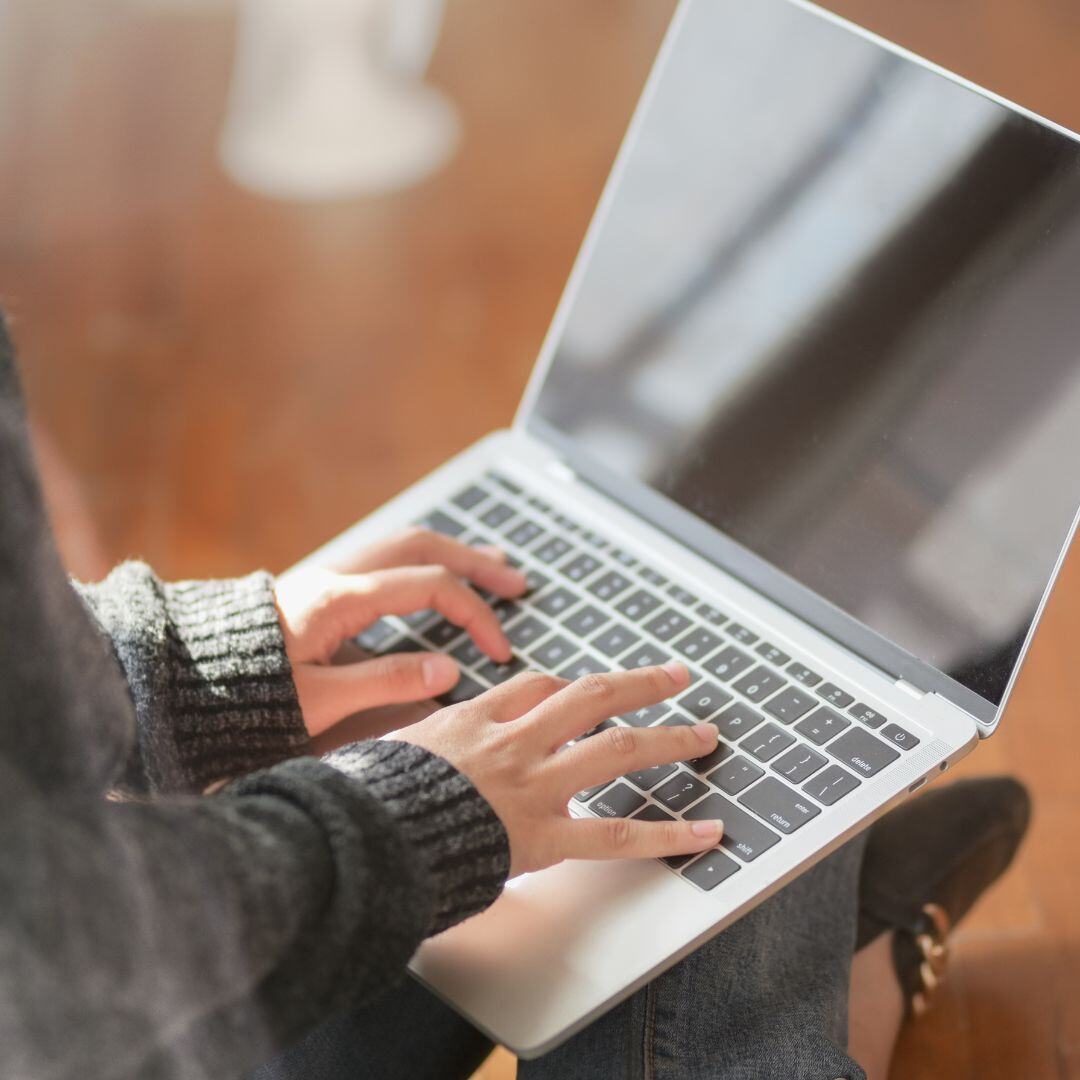 hands on a laptop